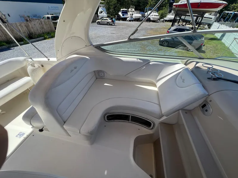 Slide: The Image of 2005 Sea Ray 280 Sundancer interior with white seating and dashboard view. - 17