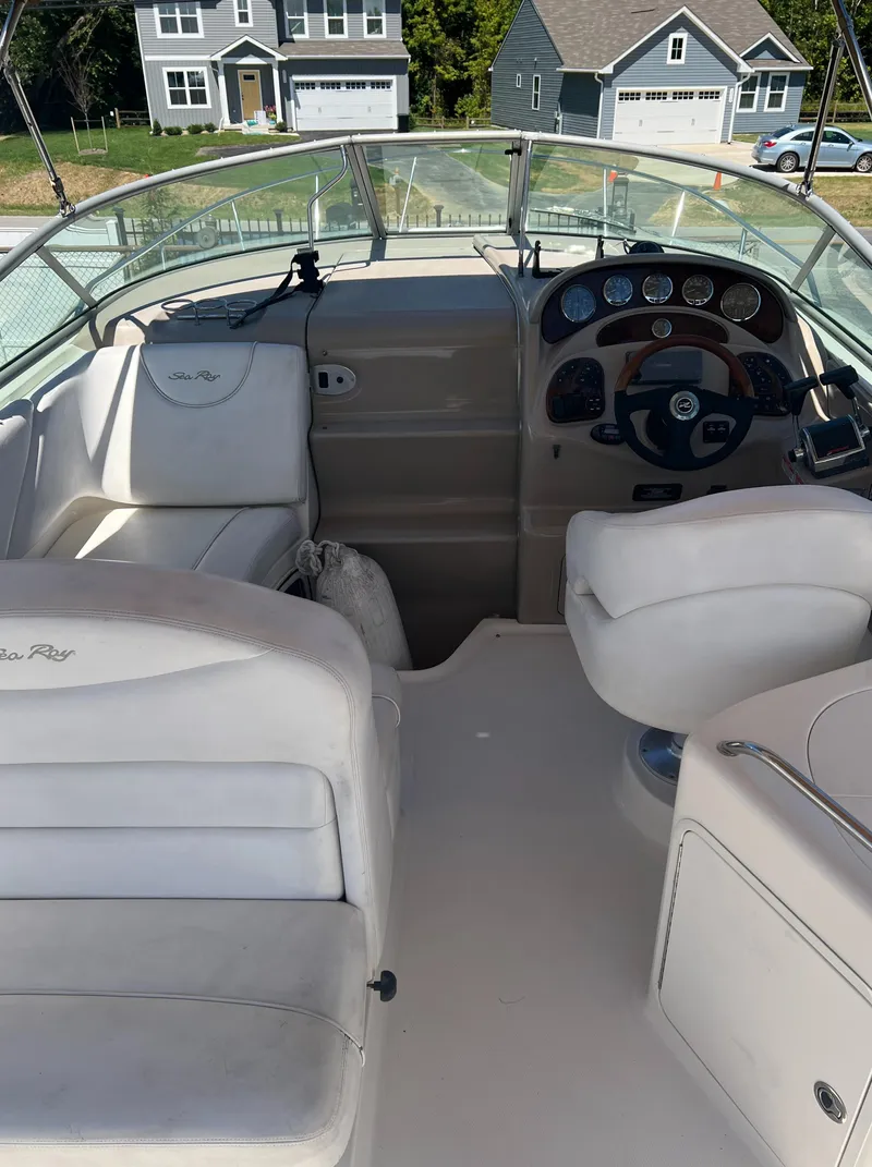 Slide: The Image of 2005 Sea Ray 280 Sundancer boat interior with steering wheel and seating. - 25