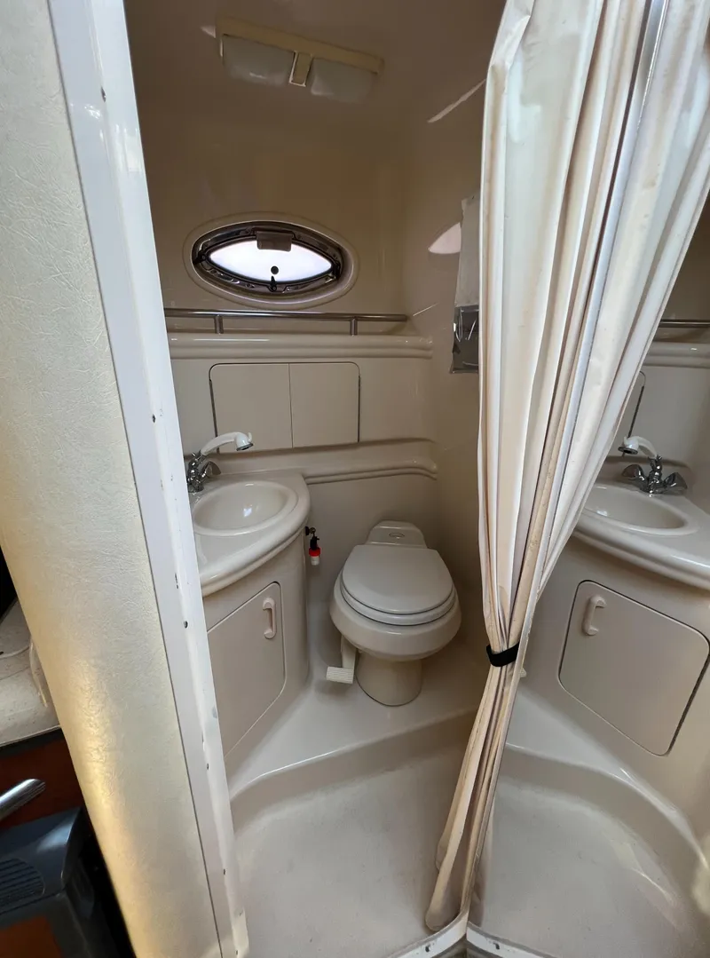 Slide: The Image of 2005 Sea Ray 280 Sundancer bathroom with shower, sink, and toilet. - 30