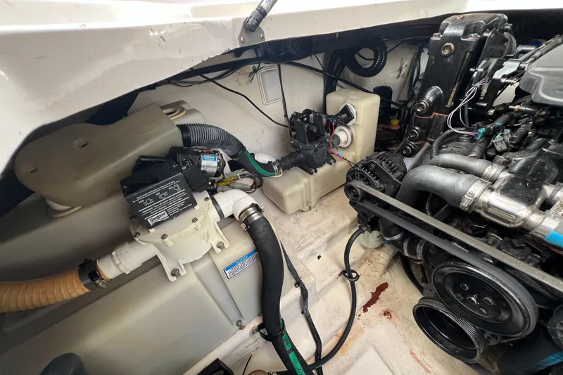 Slide: The Image of Engine compartment of 2005 Sea Ray 280 Sundancer boat, showing mechanical components and wiring. - 37