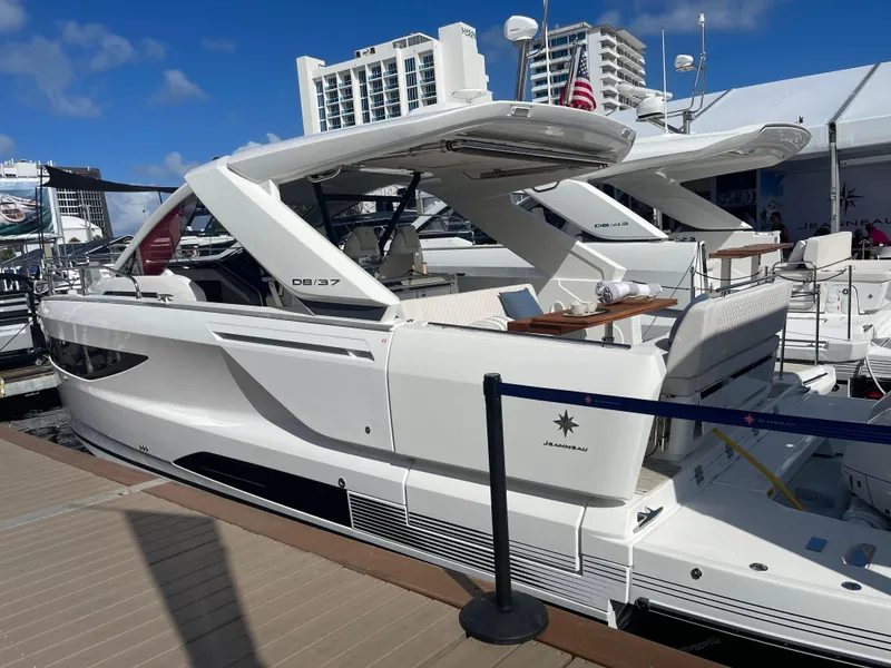 Slide: The Image of 2025 Jeanneau DB/37 OB luxury yacht docked at marina under clear blue sky. - 1