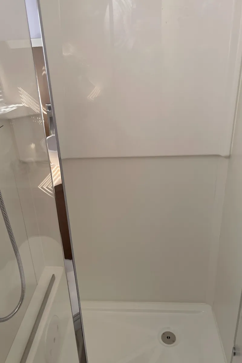 Slide: The Image of 2025 Jeanneau DB/37 OB boat shower interior with sleek, modern design. - 14