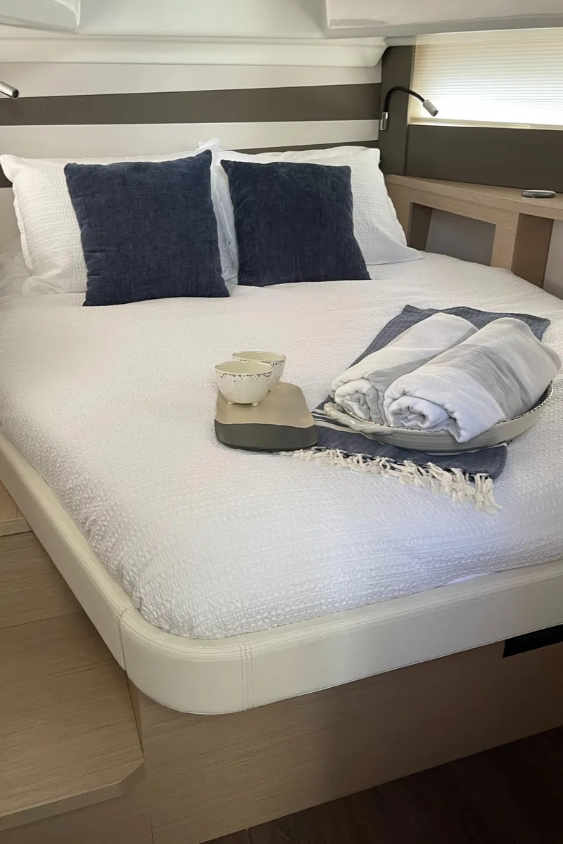 Slide: The Image of Luxurious bedroom interior of 2025 Jeanneau DB/37 OB yacht with cozy bedding. - 16