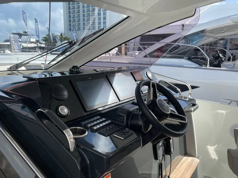 Slide: The Image of 2025 Jeanneau DB/37 OB yacht cockpit with modern navigation controls and steering wheel. - 3