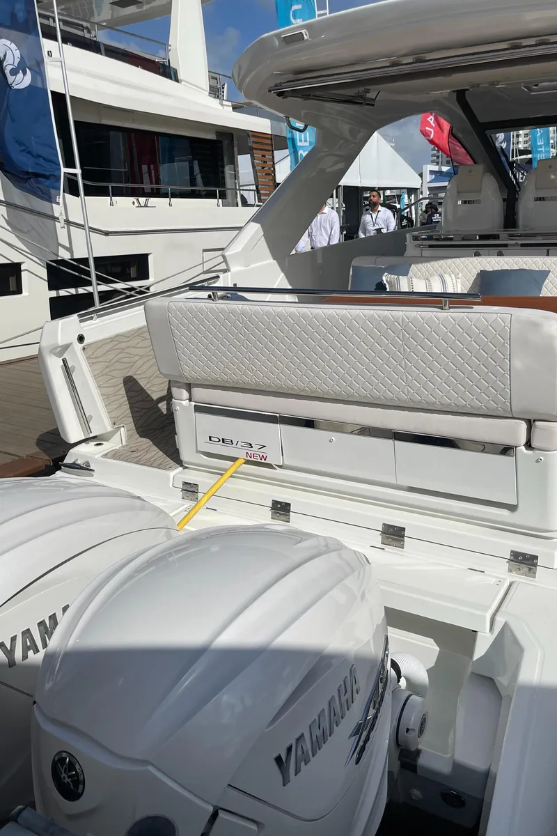 Slide: The Image of 2025 Jeanneau DB/37 OB boat with Yamaha outboard engines, docked at a marina. - 6