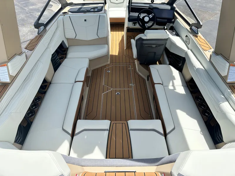 Slide: The Image of 2025 Nautique Super Air Nautique G23 interior with luxurious seating and sleek design. - 14