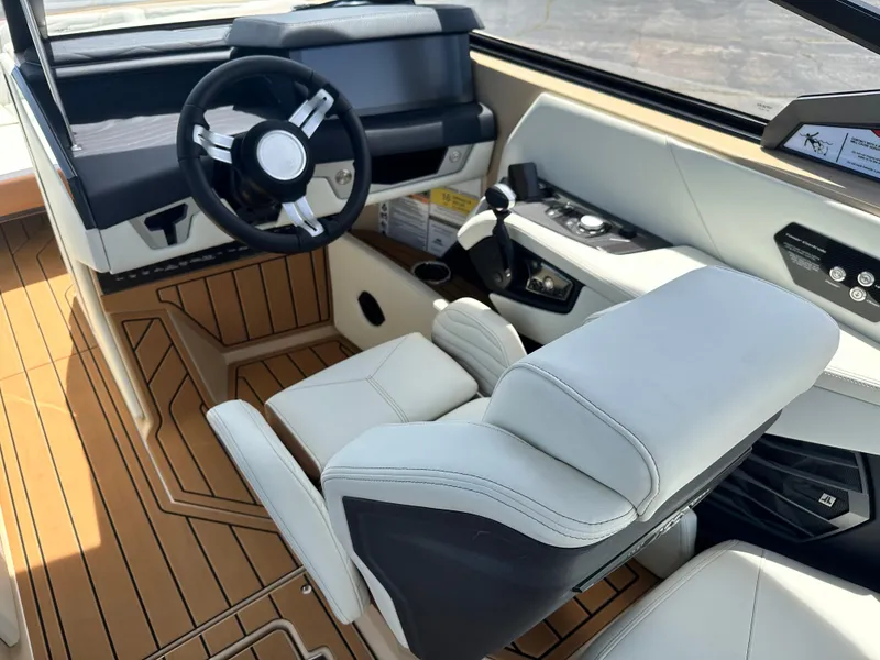 Slide: The Image of 2025 Nautique Super Air Nautique G23 cockpit with modern steering and luxurious seating. - 15