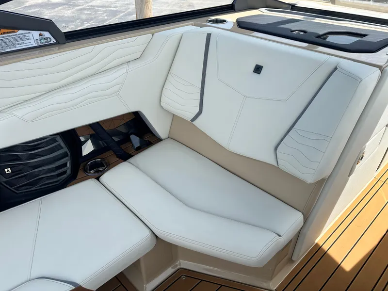 Slide: The Image of 2025 Nautique Super Air Nautique G23 interior with white leather seating and modern design. - 16