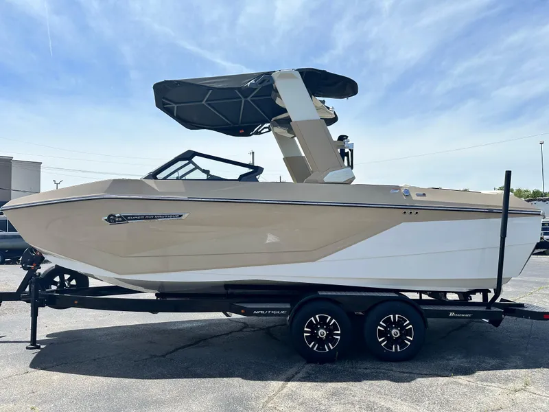Slide: The Image of 2025 Nautique Super Air Nautique G23 boat on trailer, side view, under clear sky. - 6
