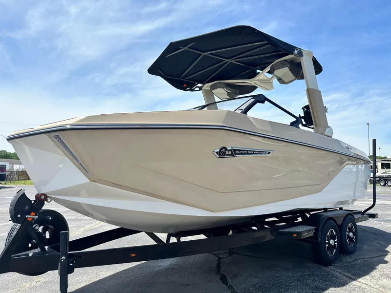 Slide: The Image of 2025 Nautique Super Air Nautique G23 boat on trailer, sleek design, outdoor setting. - 7