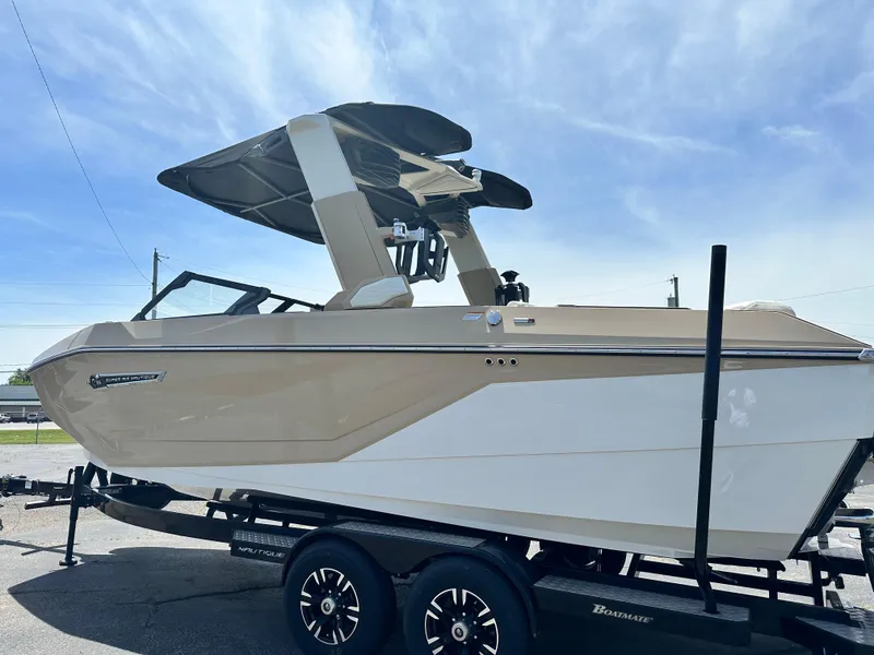 Slide: The Image of 2025 Nautique Super Air Nautique G23 boat on trailer under clear sky. - 8