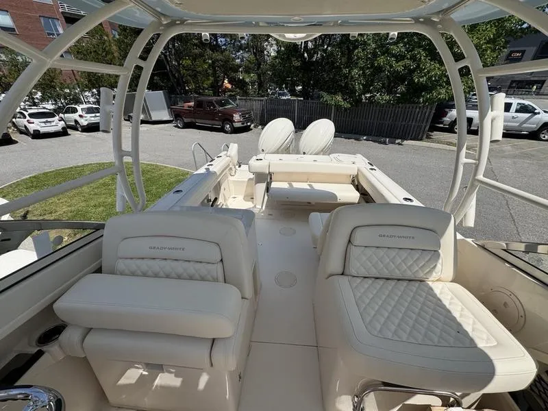 Slide: The Image of 2025 Grady-White Freedom 275 boat interior with luxurious seating and open deck. - 12