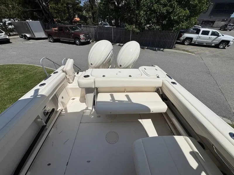 Slide: The Image of 2025 Grady-White Freedom 275 boat interior with seating and dual outboard motors. - 5