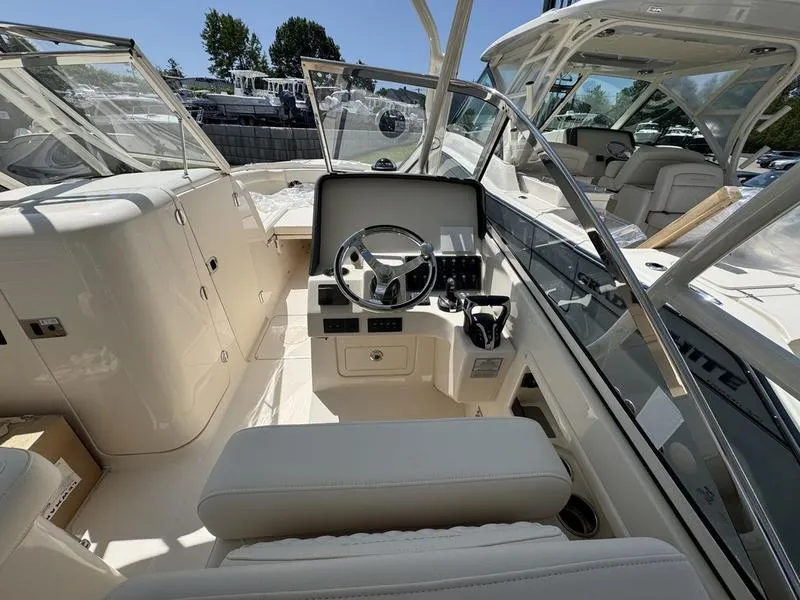 Slide: The Image of 2025 Grady-White Freedom 275 boat interior with steering wheel and seating. - 9