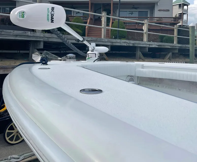 Slide: The Image of 2009 Yellowfin 36 Center Console boat with trolling motor, docked near wooden pier. - 5