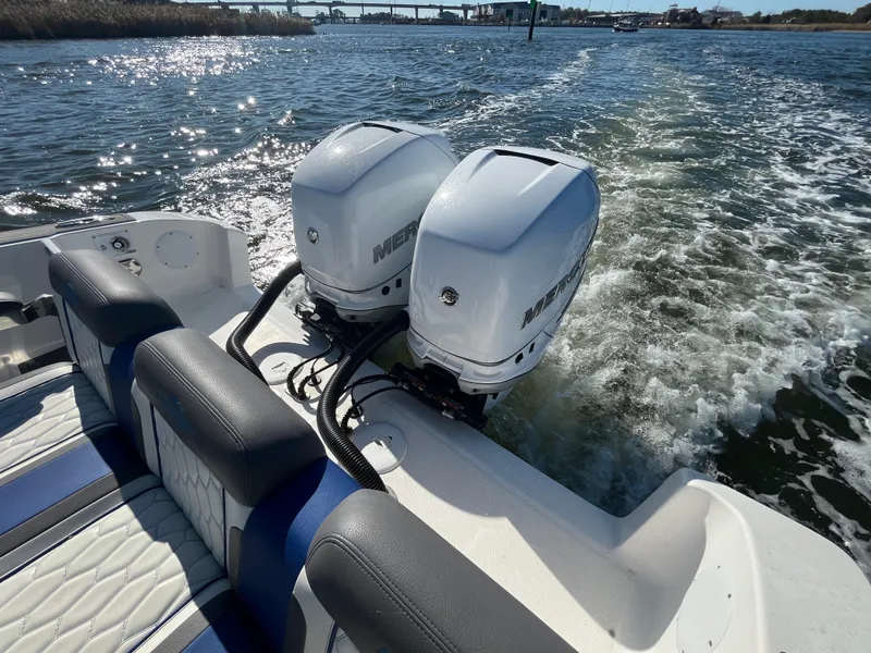 Slide: The Image of 2022 Fountain 34 SC boat with dual Mercury outboard engines on water. - 10