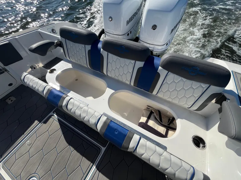 Slide: The Image of 2022 Fountain 34 SC boat interior with seating and twin Mercury engines. - 13