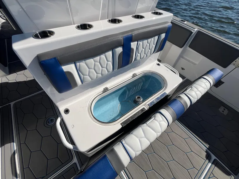 Slide: The Image of 2022 Fountain 34 SC boat interior with seating and storage compartment. - 15