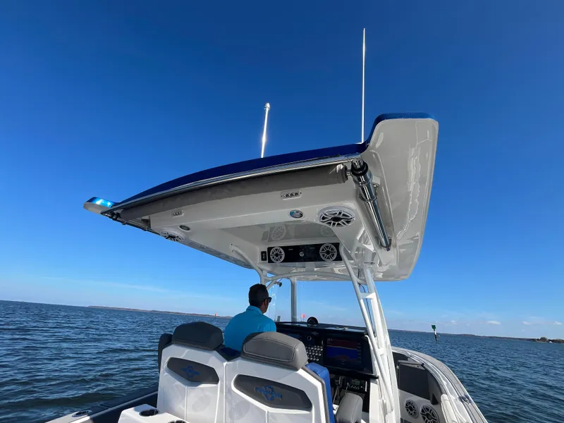 Slide: The Image of 2022 Fountain 34 SC boat on open water under clear blue sky. - 18