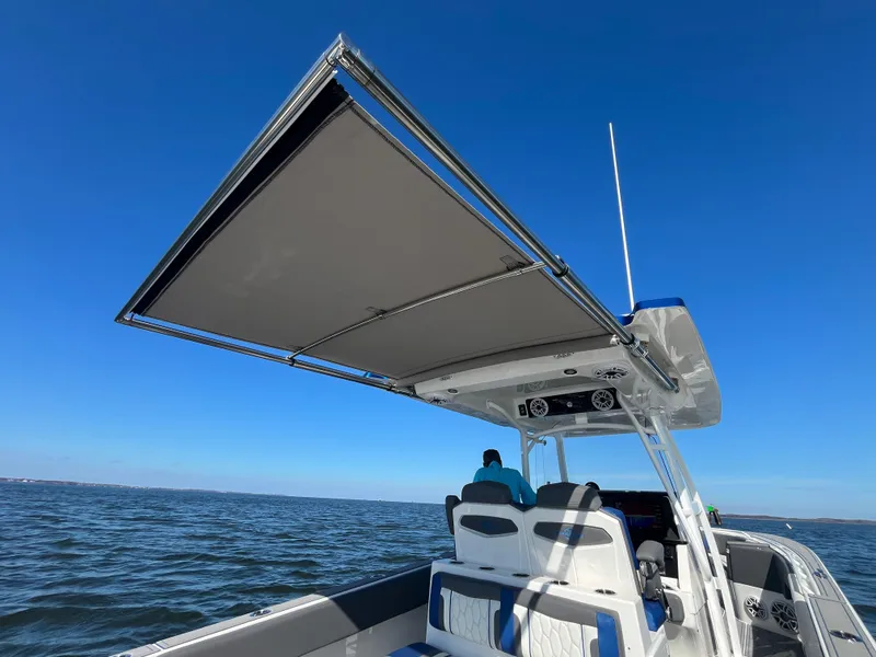 Slide: The Image of 2022 Fountain 34 SC boat with canopy on open water. - 19