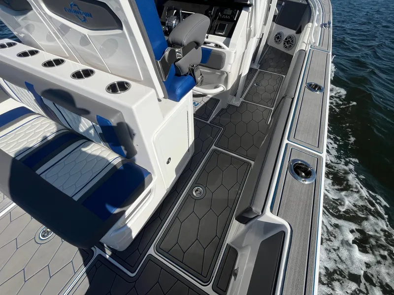 Slide: The Image of 2022 Fountain 34 SC boat interior with sleek seating and modern design on the water. - 20