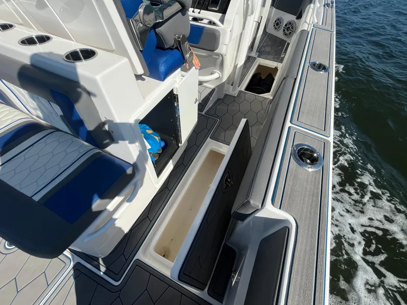 Slide: The Image of 2022 Fountain 34 SC boat interior with storage compartments and seating. - 21
