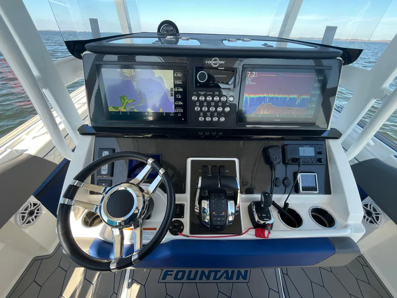 Slide: The Image of 2022 Fountain 34 SC boat dashboard with navigation screens and controls. - 24