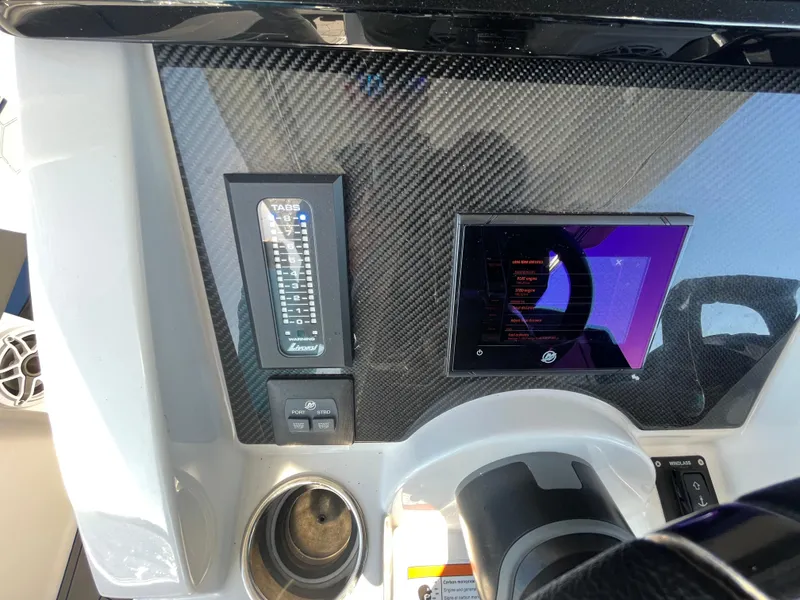 Slide: The Image of 2022 Fountain 34 SC dashboard with carbon fiber finish and digital display. - 27