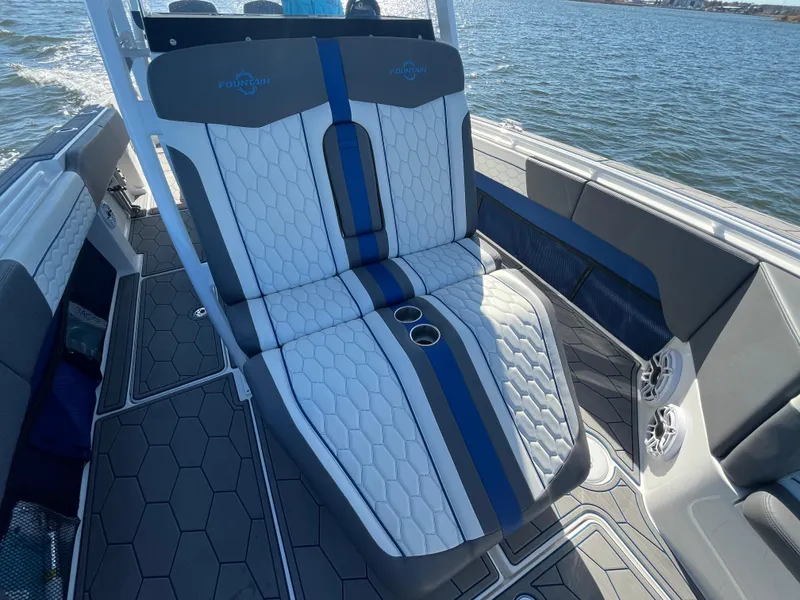 Slide: The Image of 2022 Fountain 34 SC boat interior with stylish seating and cup holders on the water. - 33