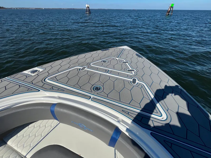 Slide: The Image of 2022 Fountain 34 SC boat on open water, featuring sleek deck design. - 38