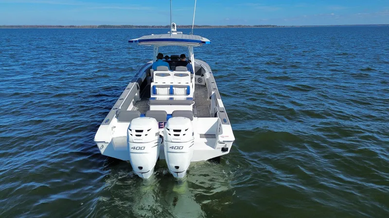 Slide: The Image of 2022 Fountain 34 SC boat with twin engines cruising on open water. - 4