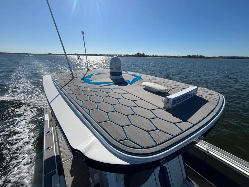 Slide: The Image of 2022 Fountain 34 SC boat cruising on open water under clear blue sky. - 41