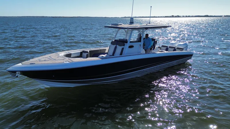 Slide: The Image of 2022 Fountain 34 SC boat cruising on open water under clear skies. - 6