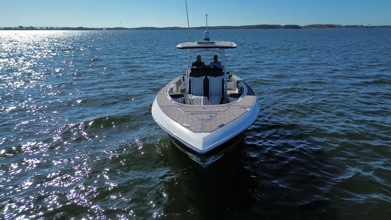 Slide: The Image of 2022 Fountain 34 SC boat cruising on open water under clear skies. - 7