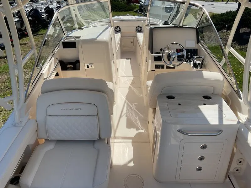Slide: The Image of 2025 Grady-White Freedom 275 boat interior with seating and twin outboard engines. - 10