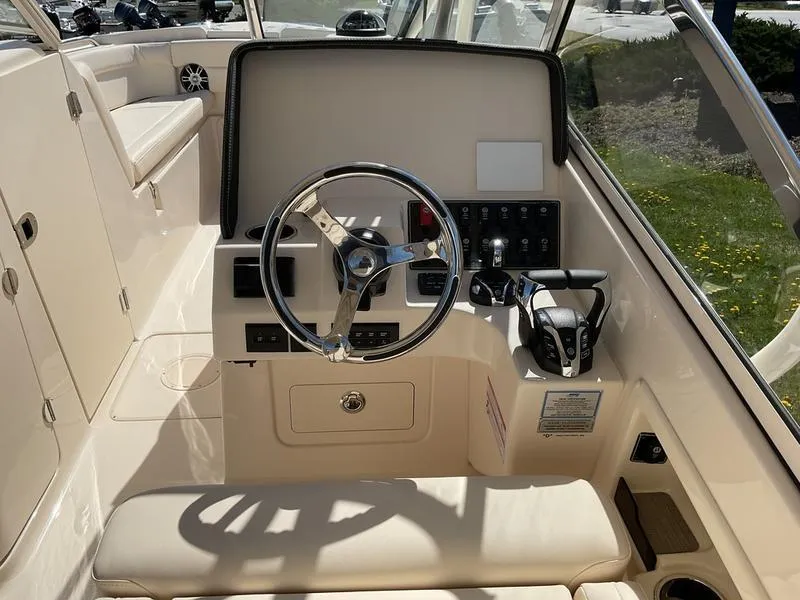 Slide: The Image of 2025 Grady-White Freedom 275 boat interior with rod holder and seating. - 11