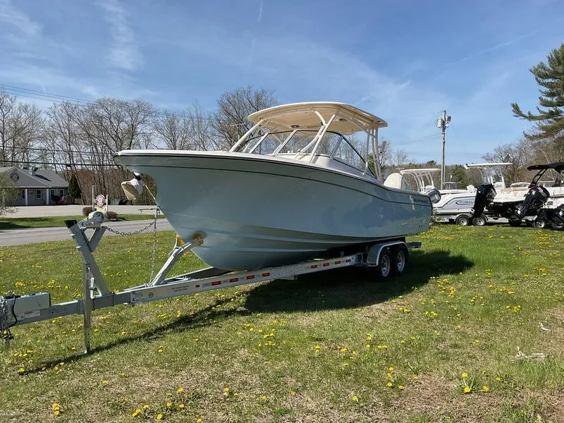 Slide: The Image of 2025 Grady-White Freedom 275 boat with dual engines on grassy area. - 5