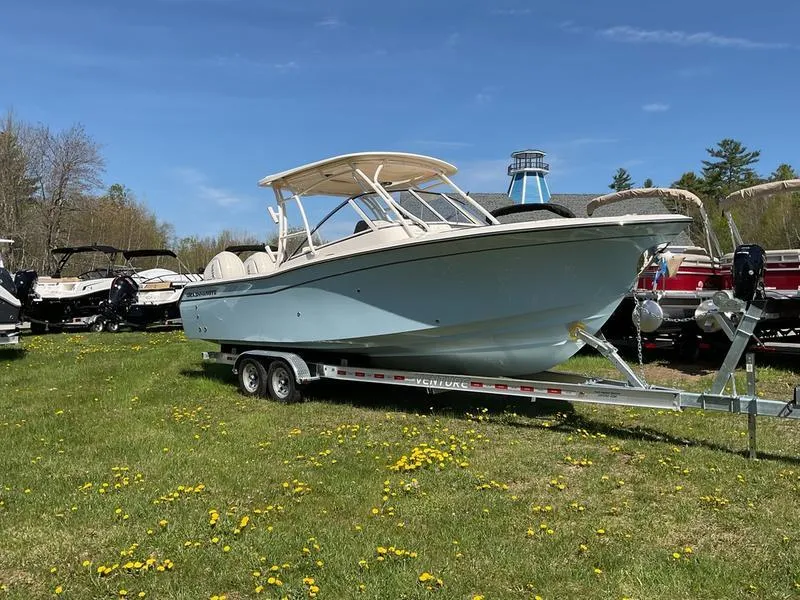 Slide: The Image of 2025 Grady-White Freedom 275 boat on trailer, twin engines, parked on grass. - 6