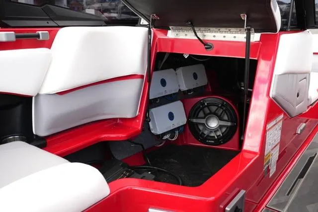 Slide: The Image of 2021 Supra SE 450 boat interior with sound system and red accents. - 13