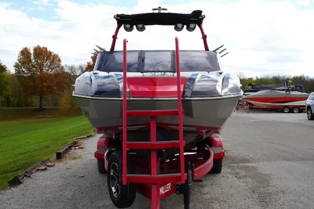 Slide: The Image of 2021 Supra SE 450 boat on trailer, front view, outdoors. - 3