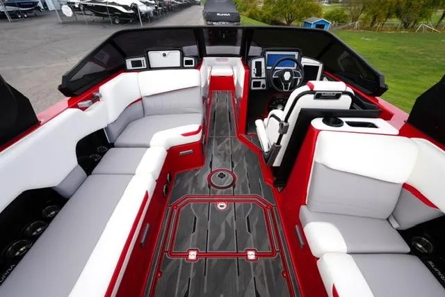 Slide: The Image of 2021 Supra SE 450 boat interior with red and white seating, modern dashboard, and sleek design. - 9