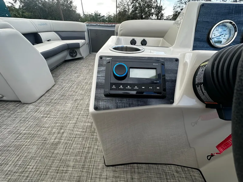 Slide: The Image of 2023 Harris Cruiser 230 boat interior with modern dashboard and seating. - 10
