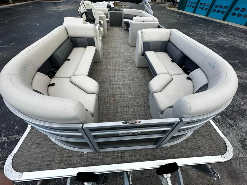 Slide: The Image of 2023 Harris Cruiser 230 pontoon boat with spacious seating and modern design. - 5