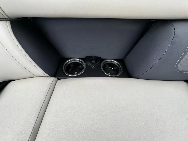 Slide: The Image of 2023 Harris Cruiser 230 interior with cup holders and beige upholstery. - 7