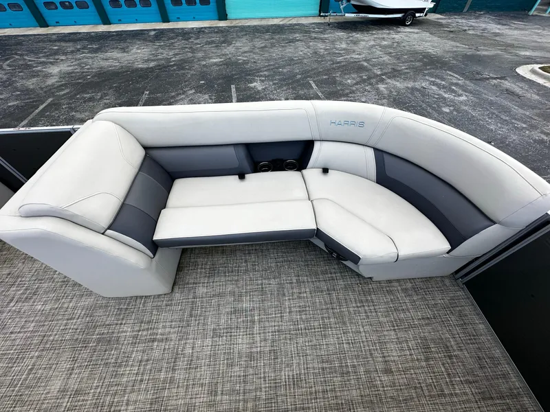 Slide: The Image of 2023 Harris Cruiser 230 boat interior with gray cushioned seating. - 8