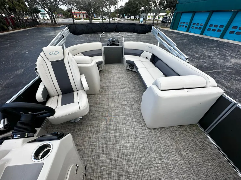 Slide: The Image of 2023 Harris Cruiser 230 pontoon boat with spacious seating and modern design. - 9