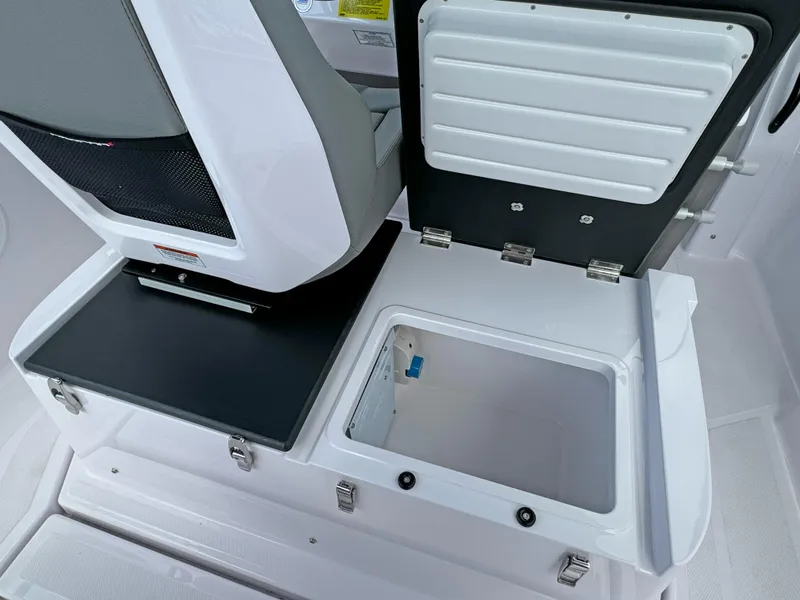 Slide: The Image of 2025 Axopar 25 Cross Top boat storage compartment and seating detail. - 10