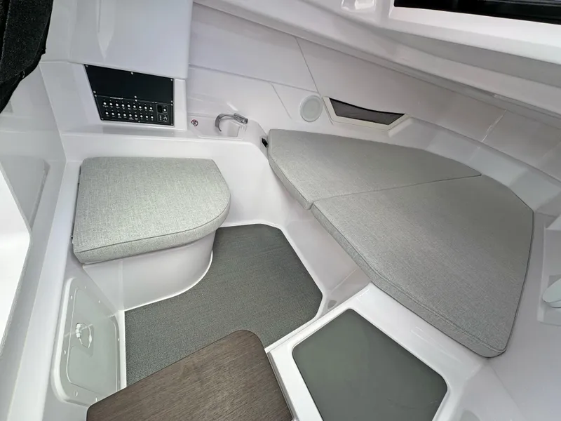 Slide: The Image of Interior of 2025 Axopar 25 Cross Top boat, featuring modern seating and control panel. - 12