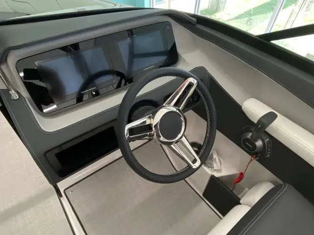 Slide: The Image of 2025 Regal LS4 boat dashboard with modern steering wheel and digital display. - 13