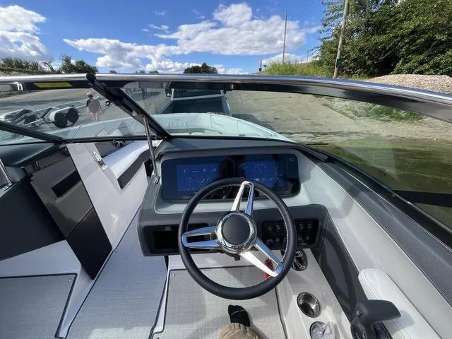 Slide: The Image of 2025 Regal LS4 boat cockpit with modern steering wheel and dashboard controls. - 14